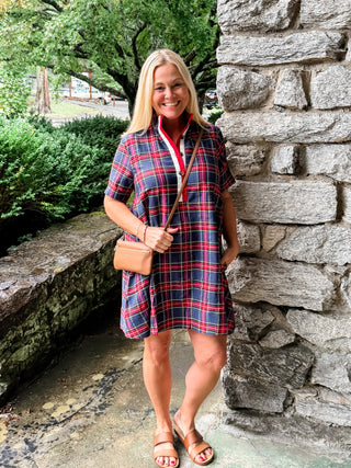 Plaid short sleeve mini dress featuring contrast buttoned placket and collar lining. Side pockets. Lined. Woven. Non-sheer. Lightweight.