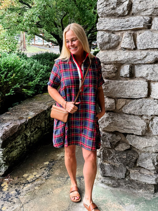 Plaid short sleeve mini dress featuring contrast buttoned placket and collar lining. Side pockets. Lined. Woven. Non-sheer. Lightweight.