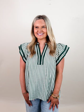 Stripe pattern flutter sleeve split V-neck top featuring contrast accent finish. Unlined. Woven. Non-sheer. Lightweight.