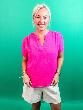 Bright Pink Top with Short Sleeves, V-Neck Cut, Lightweight Material, and Vibrant Color