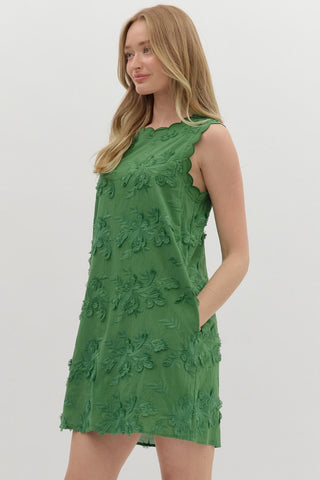 3D floral appliqué sleeveless pullover mini dress featuring embroidred scallop finish. Single button keyhole closure at back. Pockets at side. Lined. Woven. Non-sheer. Lightweight.