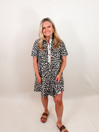 Leopard print short sleeve pullover mini dress featuring multicolor high band collar front half button closure. Pockets at sides. Lined. Woven. Non-sheer. Lightweight.