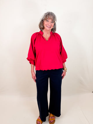 Crimson textured stop with scallop edge, balloon sleeves, and split v-neckline. Lightweight. Un-lined.