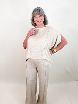 Beige Soft Knit Top with Short Slit Sleeves, Oversized Fit, and Front Seams. And Beige Soft Knit Pants with Elastic Waistband, Wide Leg fit, and Front Seam.