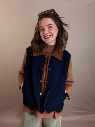 Solid sleeveless quilted corduroy quilted vest featuring contrast accent scallop hem and collar. Snap button front closure. Front pockets. Lined. Woven. Non-sheer. Lightweight.