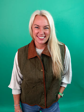 Solid sleeveless quilted corduroy quilted vest featuring contrast accent scallop hem and collar. Snap button front closure. Front pockets. Lined. Woven. Non-sheer. Lightweight.