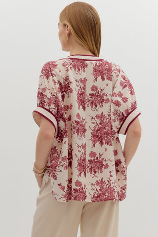 Floral print oversized pullover short dolman sleeve top featuring multicolor band. Unlined. Woven. Non-sheer. Lightweight.