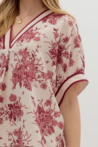 Floral print oversized pullover short dolman sleeve top featuring multicolor band. Unlined. Woven. Non-sheer. Lightweight.