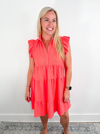 Coral tiered mini dress with ruffle cap sleeves, collared v-neck, lightweight material