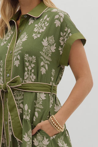 Botanical pattern faux roll-up sleeve band midi dress featuring striped accent piping trim inset. Collar button closure at front with removable belt. Side pockets. Lined. Woven. Non-sheer. Lightweight.