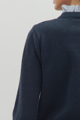 Solid long sleeve sweater knit cardigan featuring striped contrast ruffle details. Button front closure. Knit. Woven. Non-sheer. Lightweight.