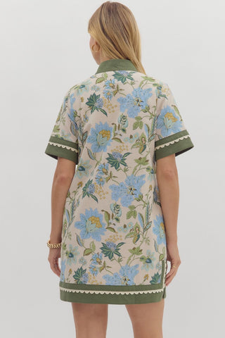 Floral print short shirt sleeve mini dress featuring contrast inset caftan- inspired neck band. Side pockets. Lined. Woven. Non-sheer. Lightweight.