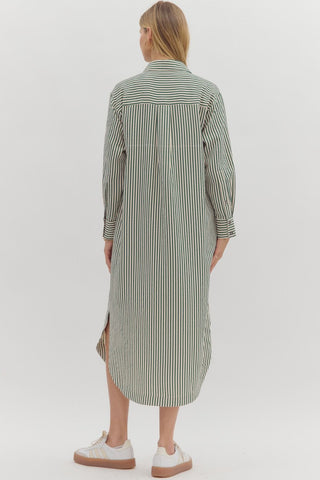 Textured stripe pattern long sleeve midi shirt dress featruing rounded slit hem. Pockets at sides. Unlined. Woven. Non-sheer. Lightweight.