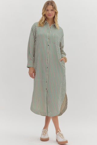 Textured stripe pattern long sleeve midi shirt dress featuring rounded slit hem. Pockets at sides. Unlined. Woven. Non-sheer. Lightweight.