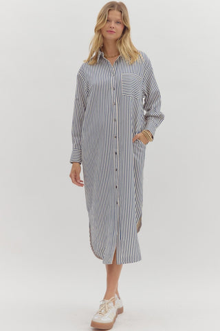 Textured stripe pattern long sleeve midi shirt dress featruing rounded slit hem. Pockets at sides. Unlined. Woven. Non-sheer. Lightweight.