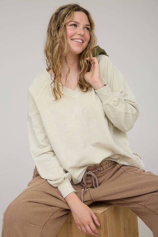 V NECKLINE LONG SLEEVES EXTENDED SHOULDER EXPOSED SEAM PATCHWORK DETAIL WASHED KNIT TOP