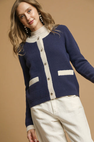 Two-Tone Button Front Cardigan Sweater with round crew neckline, two front patch pockets, contrast trim, and metallic buttons.
