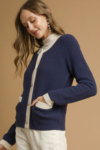 Two-Tone Button Front Cardigan Sweater with round crew neckline, two front patch pockets, contrast trim, and metallic buttons.