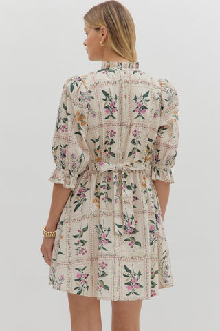 Floral panel ¾ ruffle finish puff sleeve pleated round neck button closure at front mini dress featuring adjustable back waist. Side pockets. Lined. Woven. Non-sheer. Lightweight.