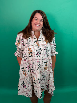 Floral panel ¾ ruffle finish puff sleeve pleated round neck button closure at front mini dress featuring adjustable back waist. Side pockets. Lined. Woven. Non-sheer. Lightweight.