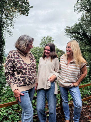 Three women standing outdoors with a natural background. Meritt Sweater Vest, Sasha Sweater, and Serena Sweater