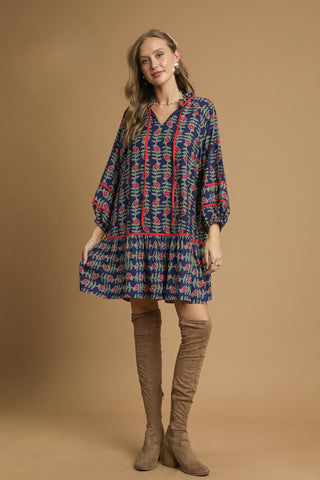 Boho-inspired Tunic Dress with Split V-Neck with Tassel Detail, Boho Contrast Piping, Three Quarter Elastic Sleeves, and Tiered Ruffle Skirt. Lined