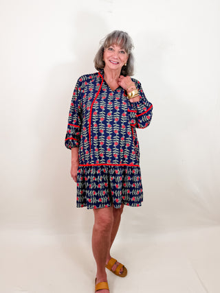 Boho-inspired Tunic Dress with Split V-Neck with Tassel Detail, Boho Contrast Piping, Three Quarter Elastic Sleeves, and Tiered Ruffle Skirt. Lined