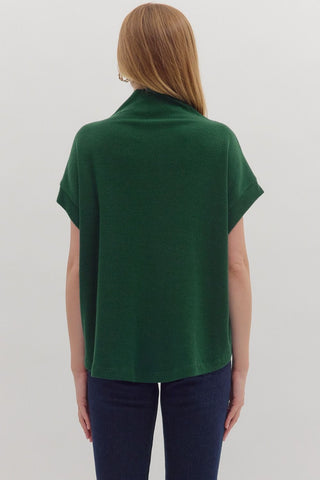 Solid short sleeve mock neck top featuring rolled cuffs. Unlined. Knit. Non-sheer. Lightweight.