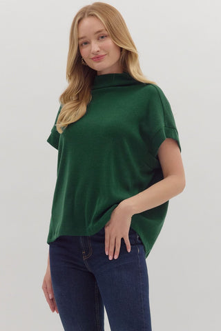Solid short sleeve mock neck top featuring rolled cuffs. Unlined. Knit. Non-sheer. Lightweight.