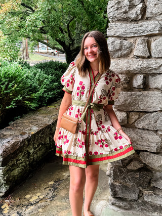 Floral pattern short puff sleeve ruffle hem mini dress featuring multicolor accent band detail. V-neck band collar button closure. Removable belt. Side pockets. Lined. Woven. Non-sheer. Lightweight.