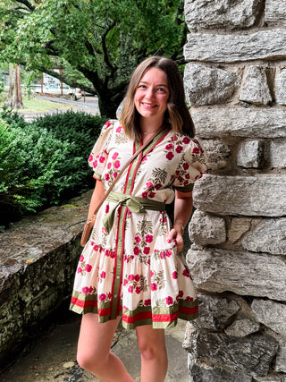 Floral pattern short puff sleeve ruffle hem mini dress featuring multicolor accent band detail. V-neck band collar button closure. Removable belt. Side pockets. Lined. Woven. Non-sheer. Lightweight.