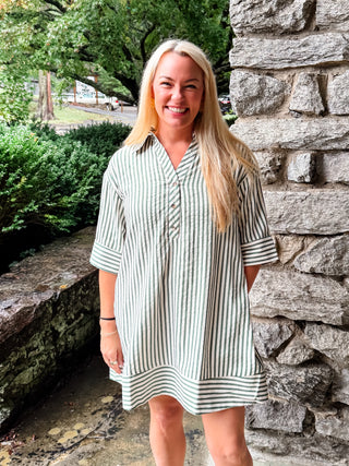 Stripe pattern ¾ cuff sleeve spread collar button front mini dress featuring pleating detail at back. Side pockets. Lined. Woven. Non-sheer. Lightweight.