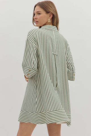 Stripe pattern ¾ cuff sleeve spread collar button front mini dress featuring pleating detail at back. Side pockets. Lined. Woven. Non-sheer. Lightweight.