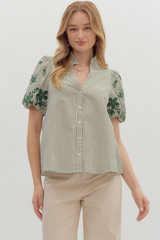 Stripe pattern V-neck ruffle band collar button front top featuring floral embroidered short bubble sleeve. Unlined. Woven. Non-sheer. Lightweight.