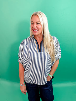 Stripe pattern high neck elasticated sleeve band dolman top featuring accented multicolor rib band split neck. Unlined. Woven. Non-sheer. Lightweight.