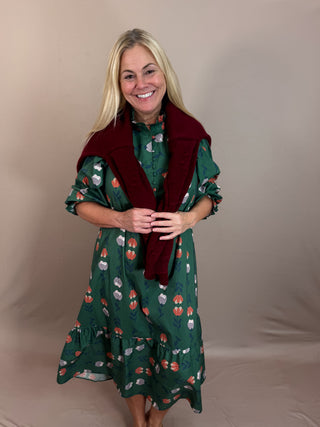 Green Floral Print Midi Dress with a High neck with subtle ruffle trim, Long puff sleeves with elastic cuffs, and tiered hem.