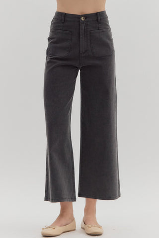 Solid high waisted wide leg ankle length pants featuring patch pockets at front. Faux pocket at back. Belt loops. Button and zipper closure at front. Unlined. Woven. Non-sheer. Lightweight.