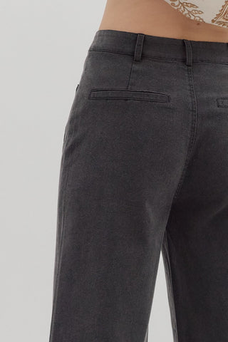 Solid high waisted wide leg ankle length pants featuring patch pockets at front. Faux pocket at back. Belt loops. Button and zipper closure at front. Unlined. Woven. Non-sheer. Lightweight.