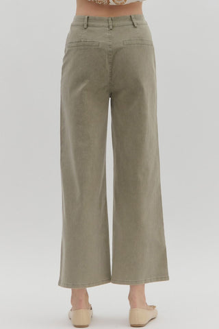 Solid high waisted wide leg ankle length pants featuring patch pockets at front. Faux pocket at back. Belt loops. Button and zipper closure at front. Unlined. Woven. Non-sheer. Lightweight.