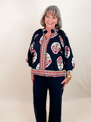 Navy boho-inspired tunic with a split v-neckline, three quarter sleeves, and a contrast border print. Unlined. Lightweight.