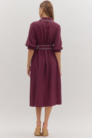 Solid short puff sleeve midi dress featuring contrast embroidered blanket stitch trim and removable belt at waist. Button closure at front. Side pockets. Lined. Woven. Non-sheer. Lightweight.