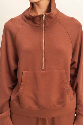 Chocolate brown cropped lightweight sweater with quarter zip, laydown collar, front pocket, and relaxed fit.