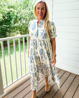 Blue and cream midi dress with two-tone paisley floral print, tiered skirt, and mandarin collar.