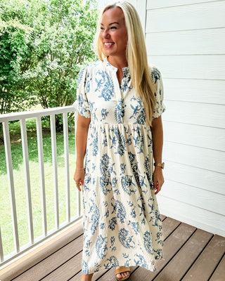 Blue and cream midi dress with two-tone paisley floral print, tiered skirt, and mandarin collar.