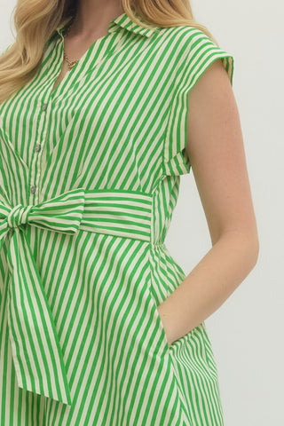 Striped cap sleeve midi dress featuring V-neck with self-tie detail at front and gathered waist. Side pockets. Lined. Woven. Non-sheer. Lightweight.