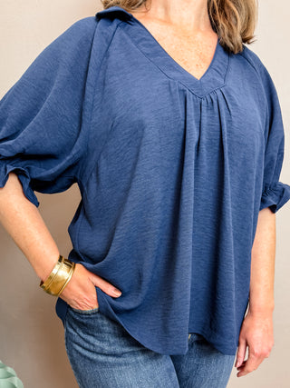 Navy Blue Solid Collared V-Neck Top with V-Neckline, Soft Collar, Short Puff Sleeves, Ruffle Trim, Self Binding Detail and Easy-Ft Silhouette