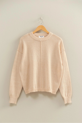 Cream soft knit sweater with cuffed sleeved and front seam