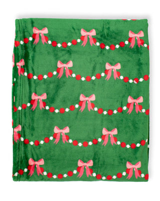 Green Throw Blanket with Pink Bow Garland. 