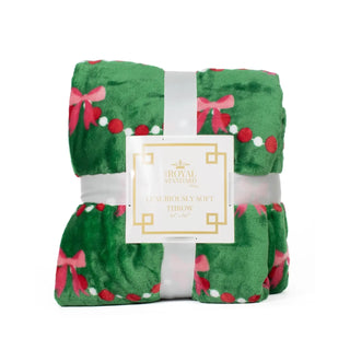 Green Throw Blanket with Pink Bow Garland. 