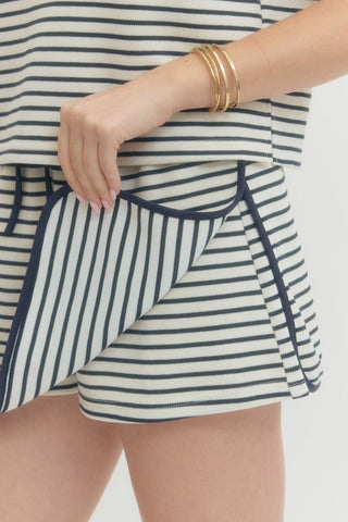 Striped knit skort featuring elasticated waistband with drawstring detail and contrast piping. Unlined. Knit. Non-sheer. Lightweight.